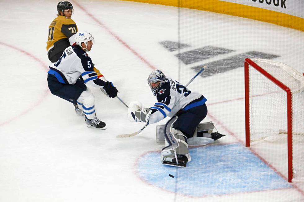 Golden Knights center William Karlsson (71) scores a goal against Winnipeg Jets goaltender Conn ...