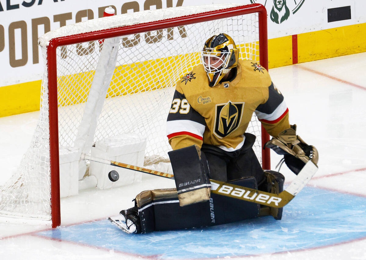 Golden Knights goaltender Laurent Brossoit (39) cannot stop a shot by Winnipeg Jets left wing K ...