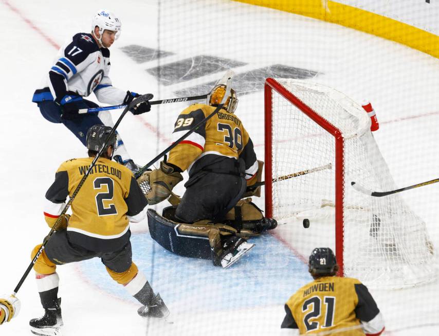 Winnipeg Jets center Adam Lowry (17) scores a goal against Golden Knights goaltender Laurent B ...