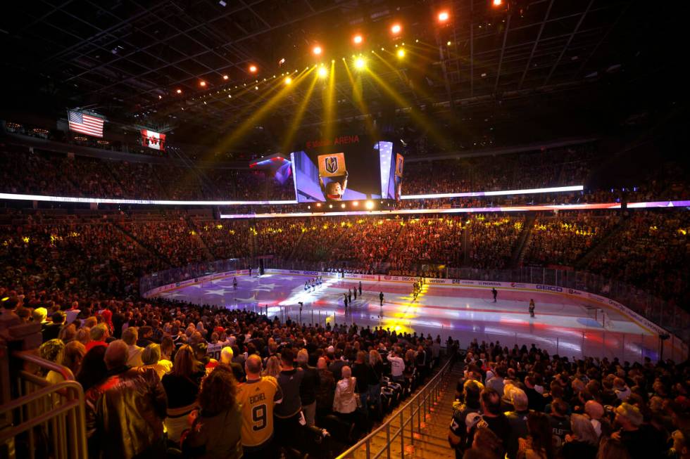 People stand up for the national anthem before the first period of Game 1 of an NHL hockey Stan ...