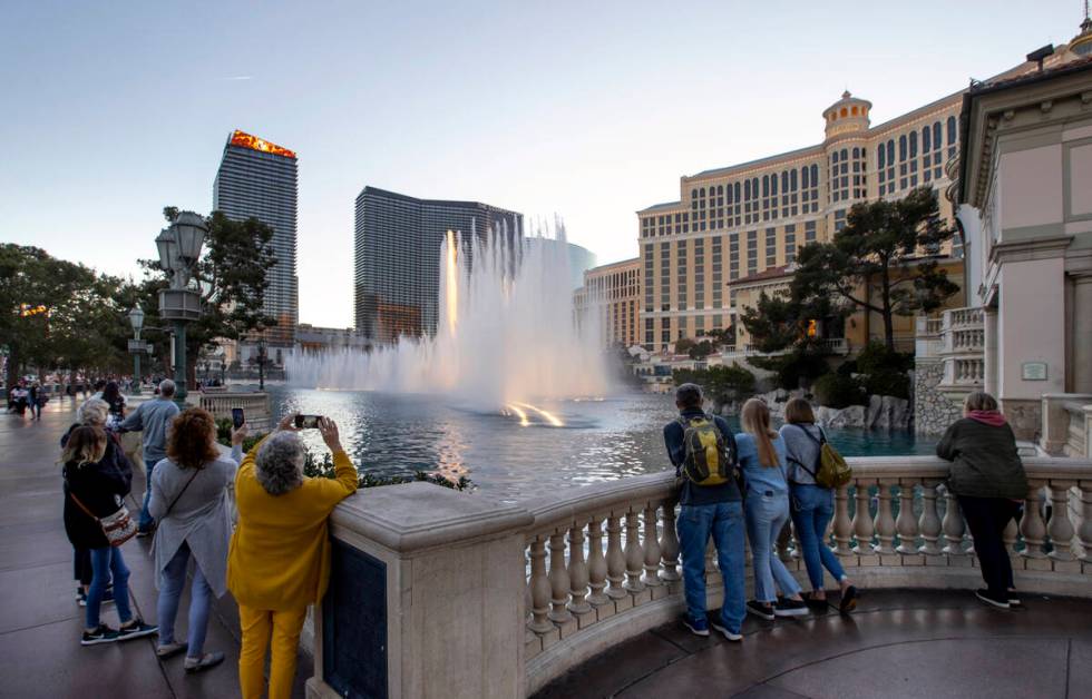 People watch the Bellagio Fountains in January 2022 in Las Vegas. (L.E. Baskow/Las Vegas Review ...