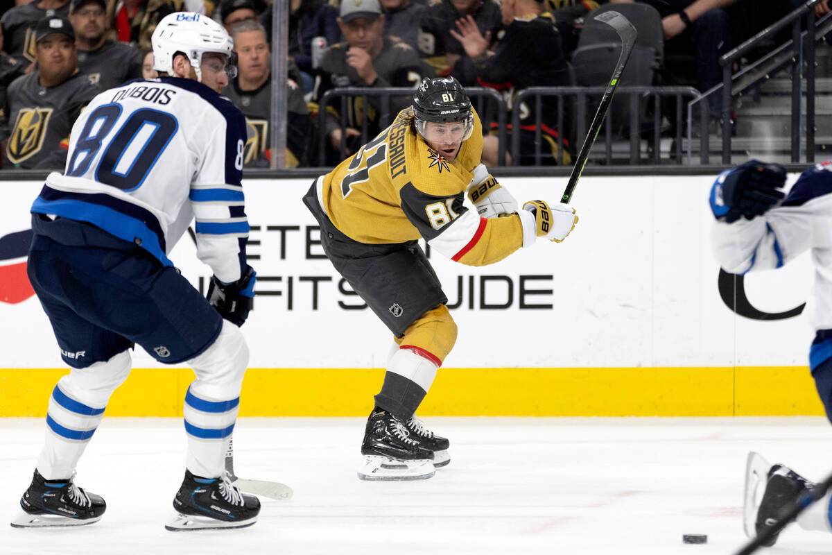 Golden Knights right wing Jonathan Marchessault (81) shoots while Jets left wing Pierre-Luc Dub ...