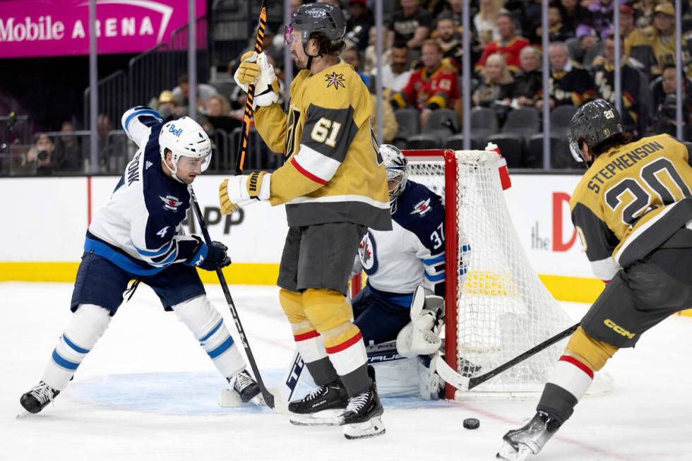 Golden Knights center Chandler Stephenson (20) shoots while right wing Mark Stone (61) blocks J ...