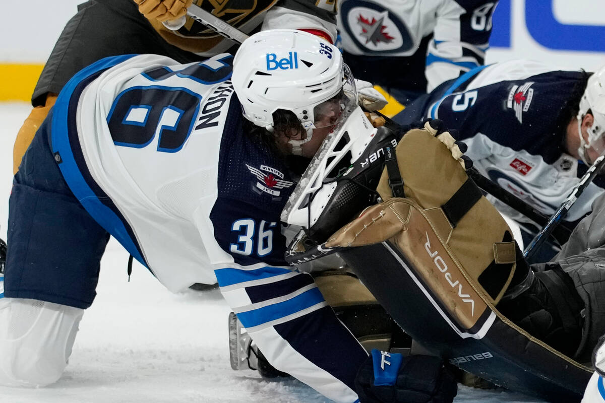 Winnipeg Jets center Morgan Barron (36) gets his face cut on the skate of Vegas Golden Knights ...