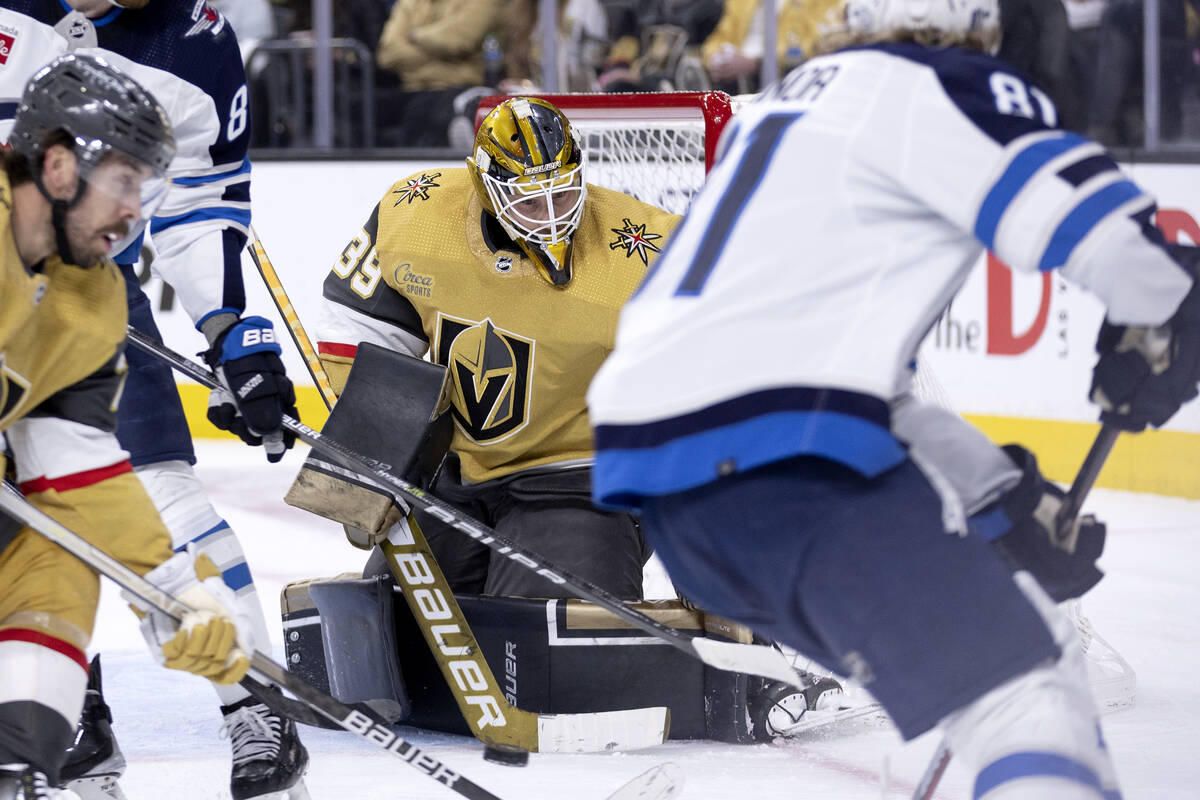 Golden Knights goaltender Laurent Brossoit (39) moves to save against Winnipeg Jets left wing K ...