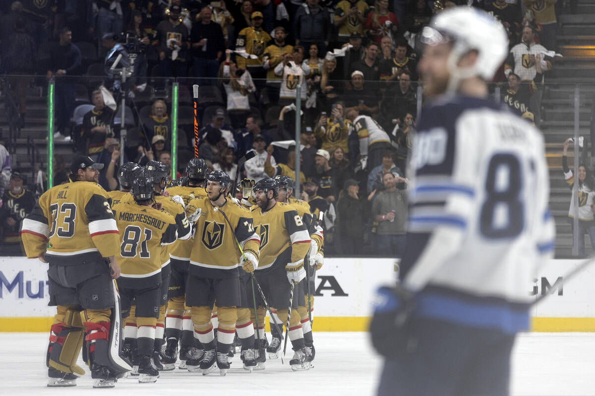 The Golden Knights celebrate after winning Game 2 of an NHL hockey Stanley Cup first-round play ...