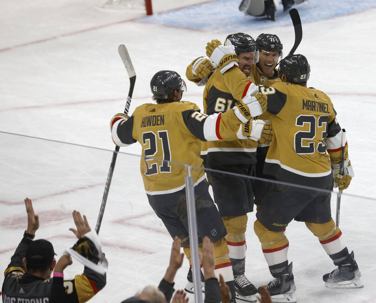 Golden Knights right wing Mark Stone (61) is congratulated by his teammates after his goal agai ...