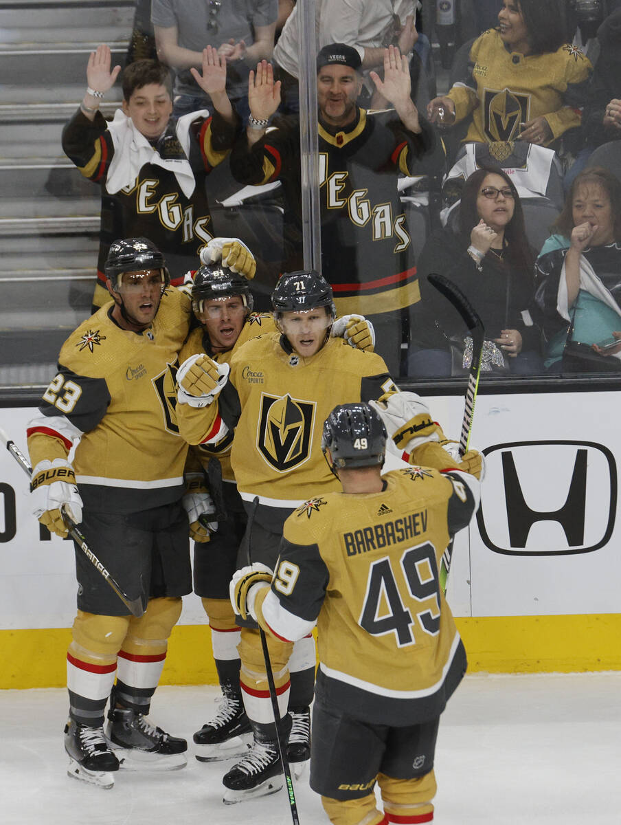 Golden Knights center William Karlsson (71), third from left, is congratulated by his teammates ...