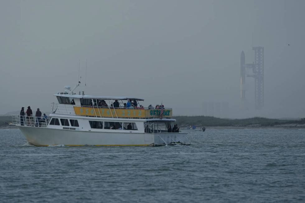 A tour boat passes SpaceX's Starship, the world's biggest and most powerful rocket, was it prep ...