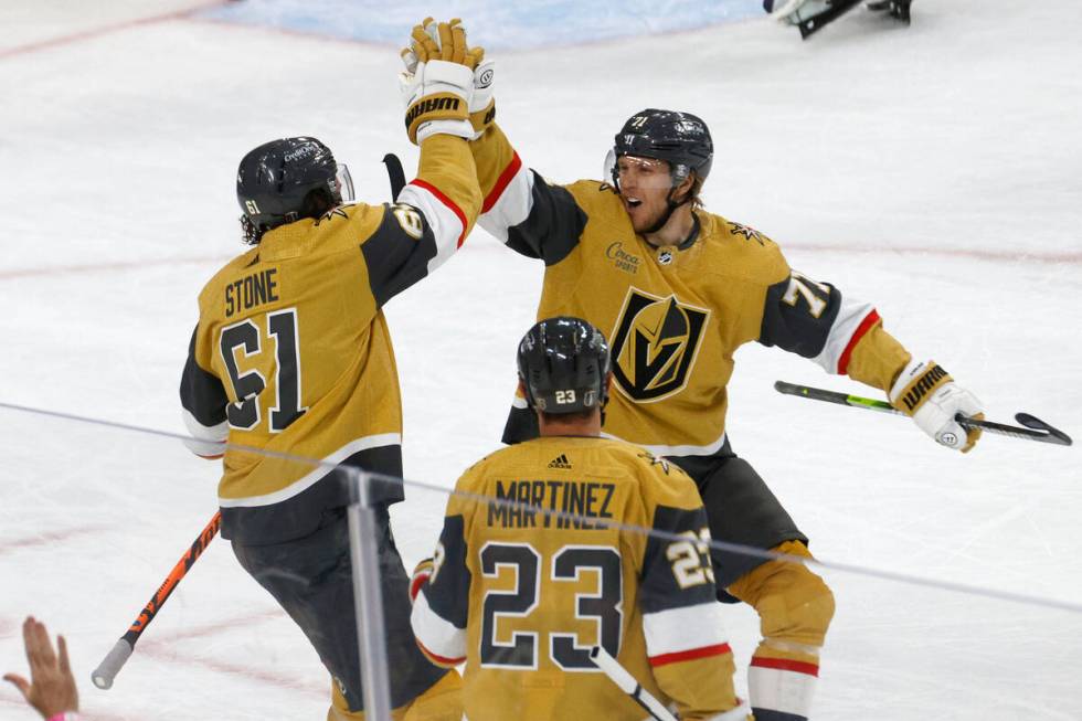 Golden Knights right wing Mark Stone (61) receives a high-five from Golden Knights center Willi ...