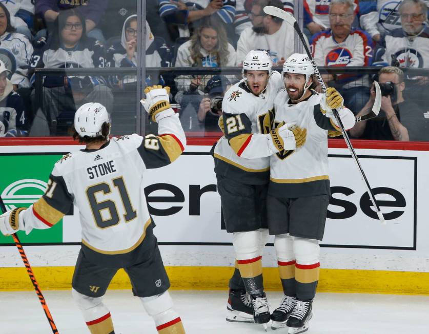 Vegas Golden Knights' Mark Stone (61), Brett Howden (21) and Chandler Stephenson (20) celebrate ...