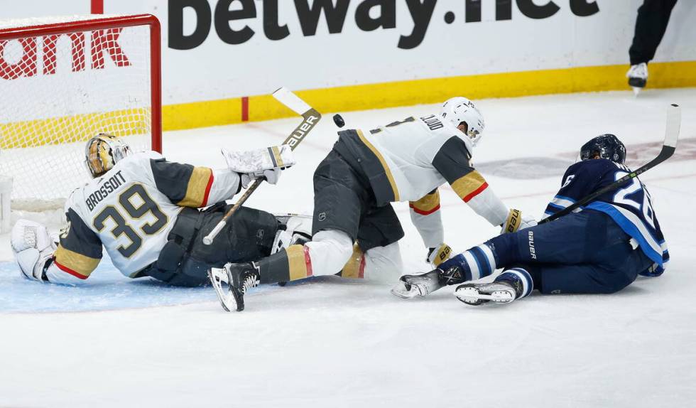 Vegas Golden Knights goaltender Laurent Brossoit (39) saves the deflection by Winnipeg Jets' Bl ...