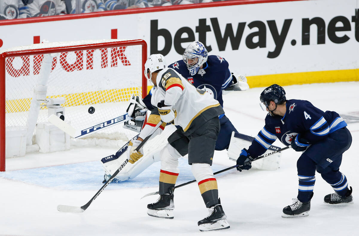 Vegas Golden Knights' Keegan Kolesar (55) scores on Winnipeg Jets goaltender Connor Hellebuyck ...