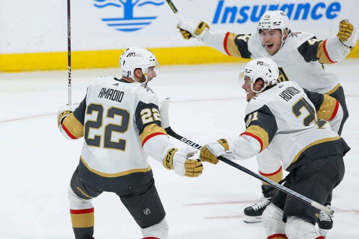 Vegas Golden Knights' Michael Amadio (22), Brett Howden (21) and Ivan Barbashev (49) celebrate ...