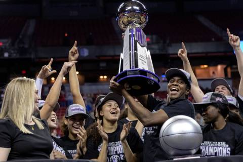 UNLV Lady Rebels center Desi-Rae Young, who was named tournament MVP, holds up her team’ ...