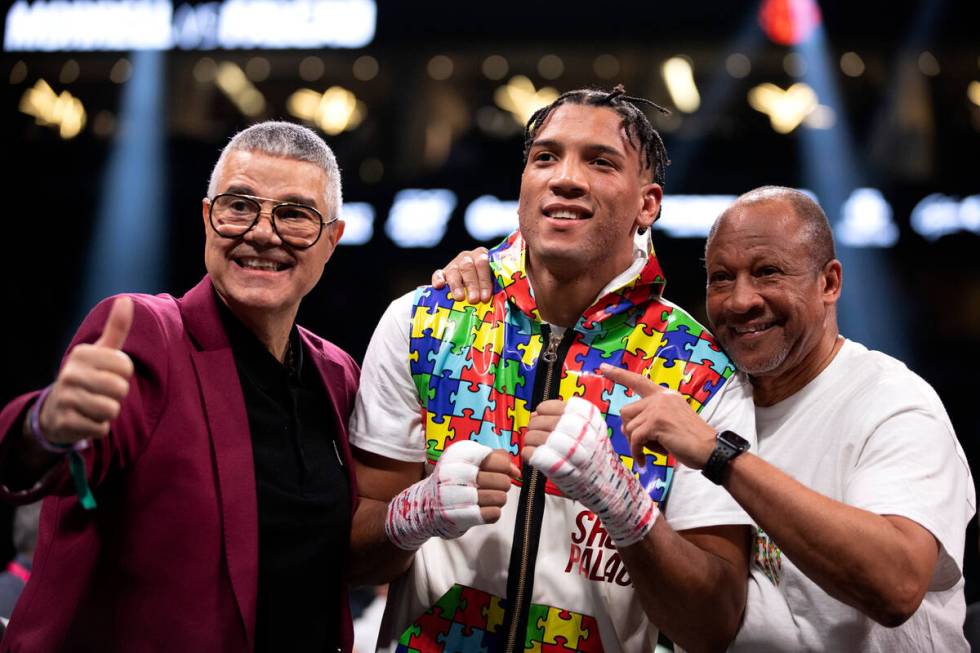 David Morrell Jr., center, poses with promoter Luis DeCubas, left, and his trainer Ronnie Shiel ...