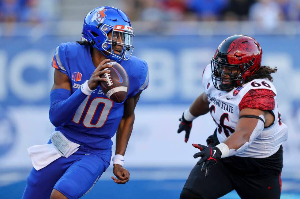 Boise State quarterback Taylen Green (10) is chased out of the pocket by San Diego State defens ...