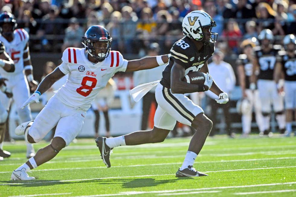 Vanderbilt wide receiver Gamarion Carter (83) runs as Mississippi linebacker Troy Brown (8) def ...