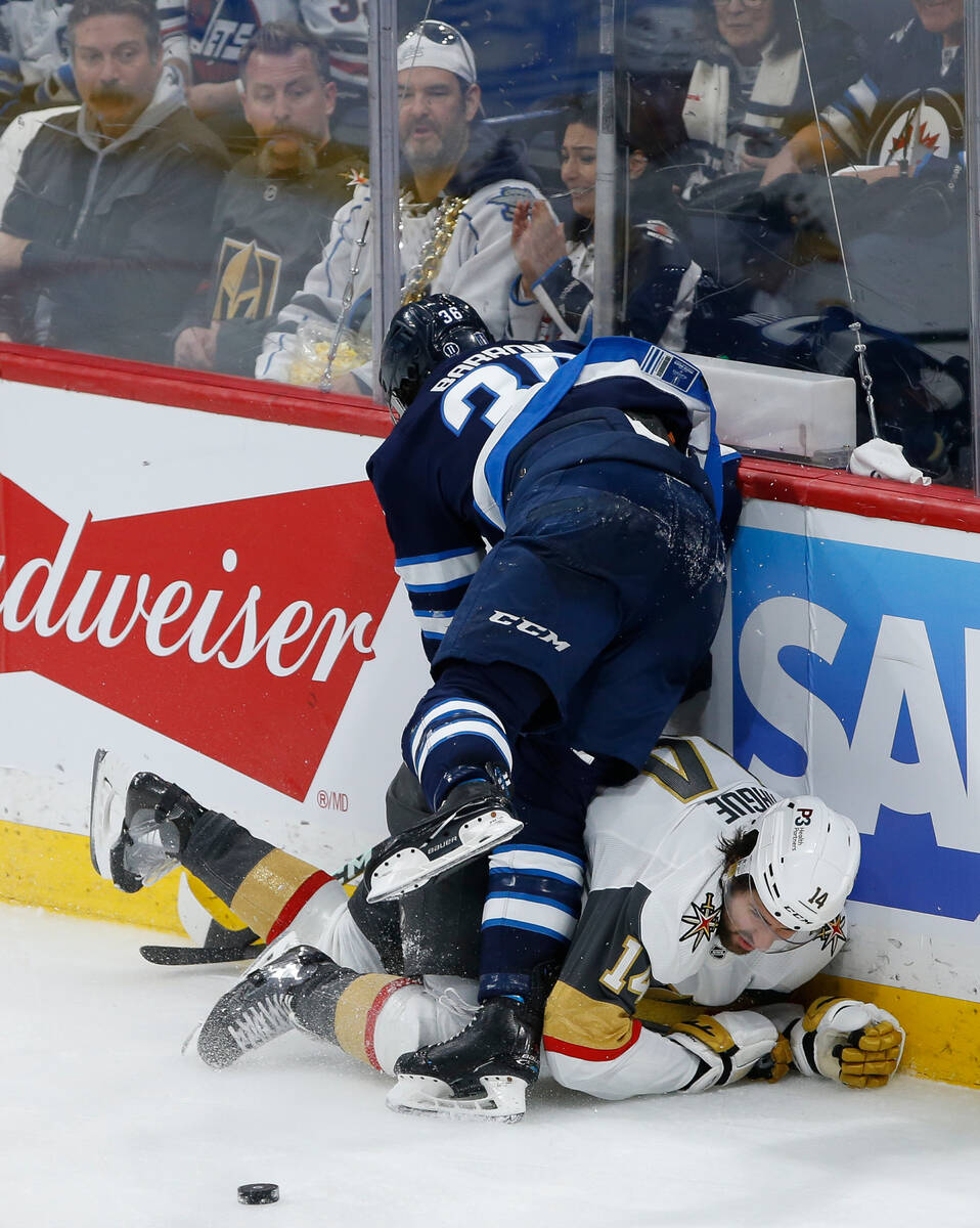 Winnipeg Jets' Morgan Barron (36) and Vegas Golden Knights' Nicolas Hague (14) collide during t ...