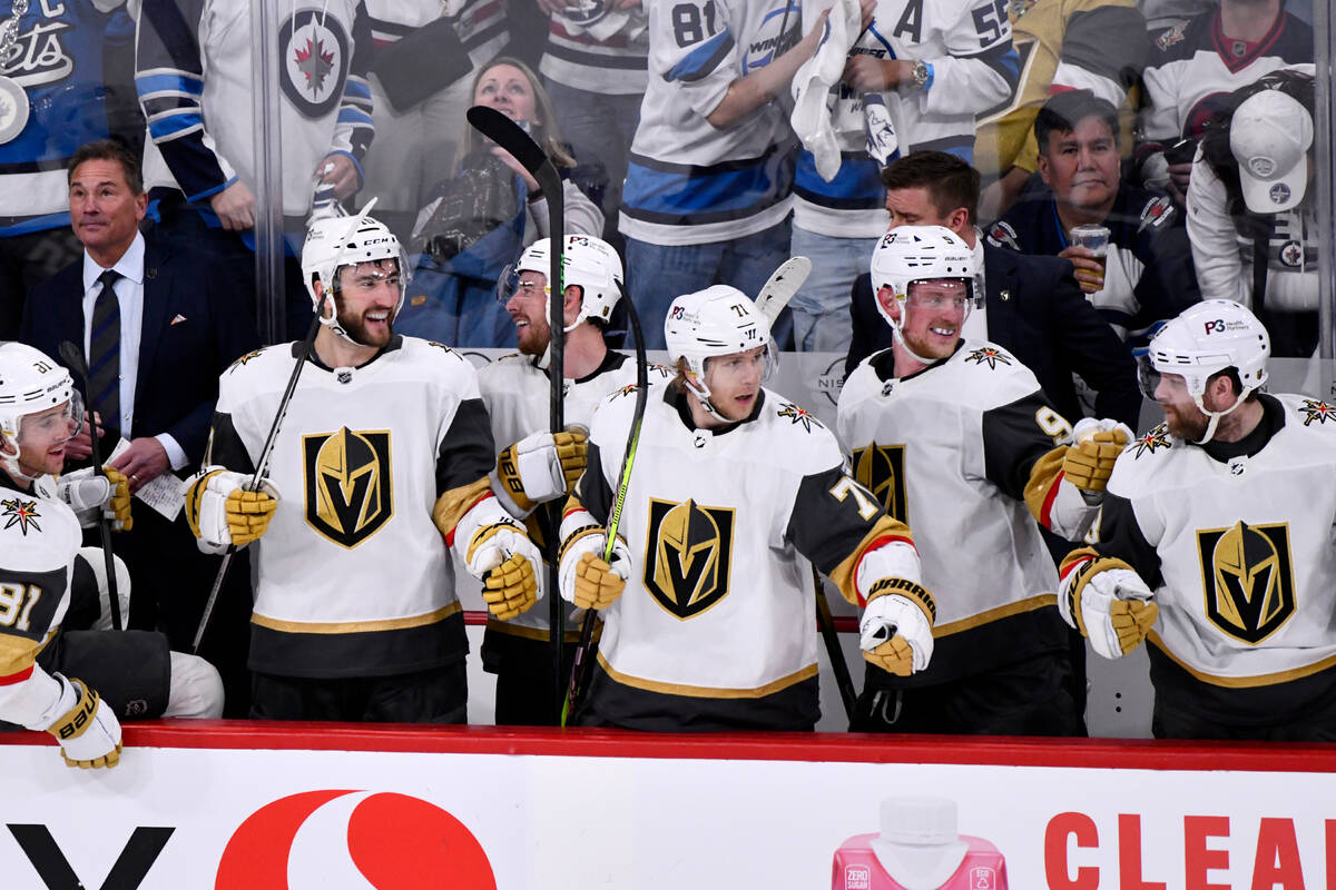 The Vegas Golden Knights bench celebrates their fourth goal against the Winnipeg Jets during th ...