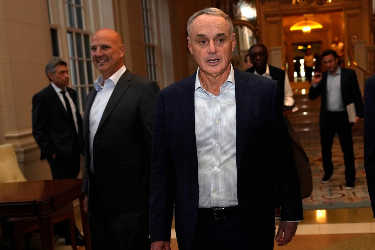 Major League Baseball Commissioner Rob Manfred leaves a meeting of MLB owners, Thursday, Feb. 9 ...