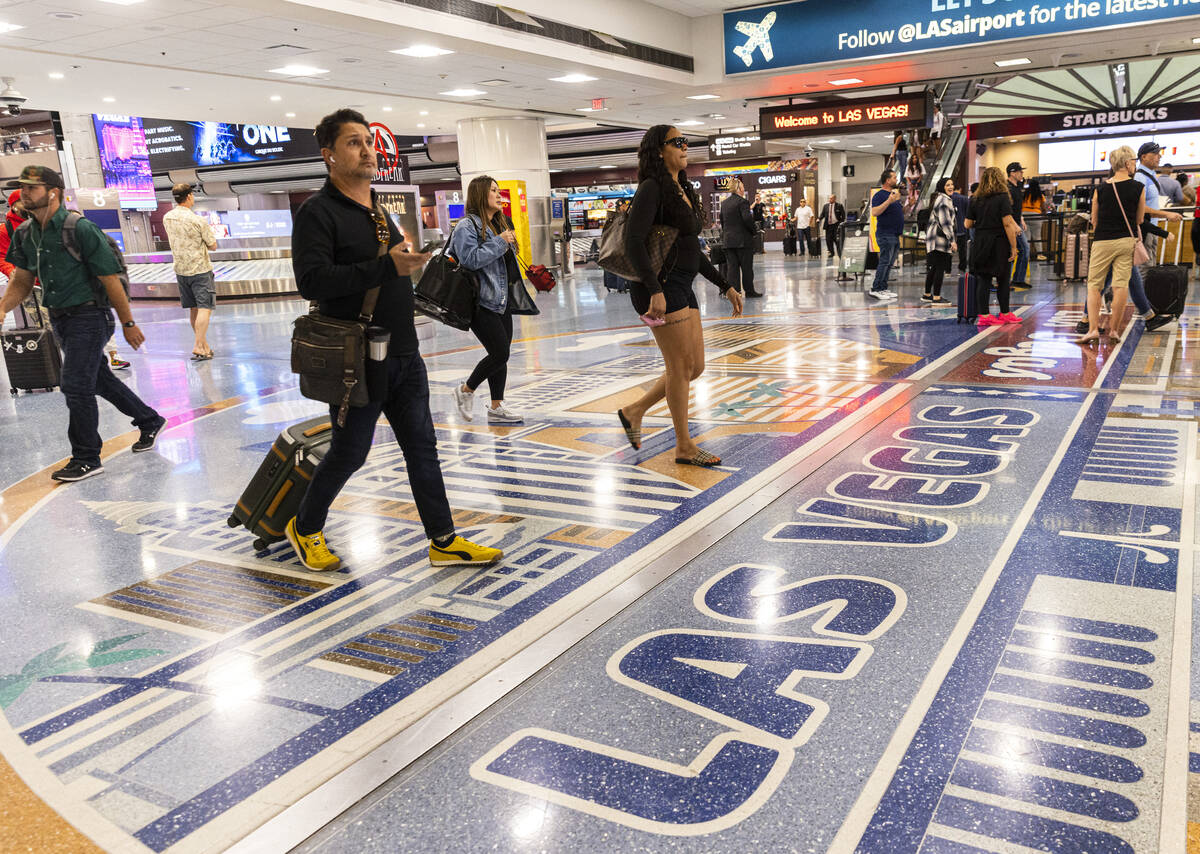 Arriving passengers head to baggage claim area in Terminal 1 of Harry Reid International Airpor ...