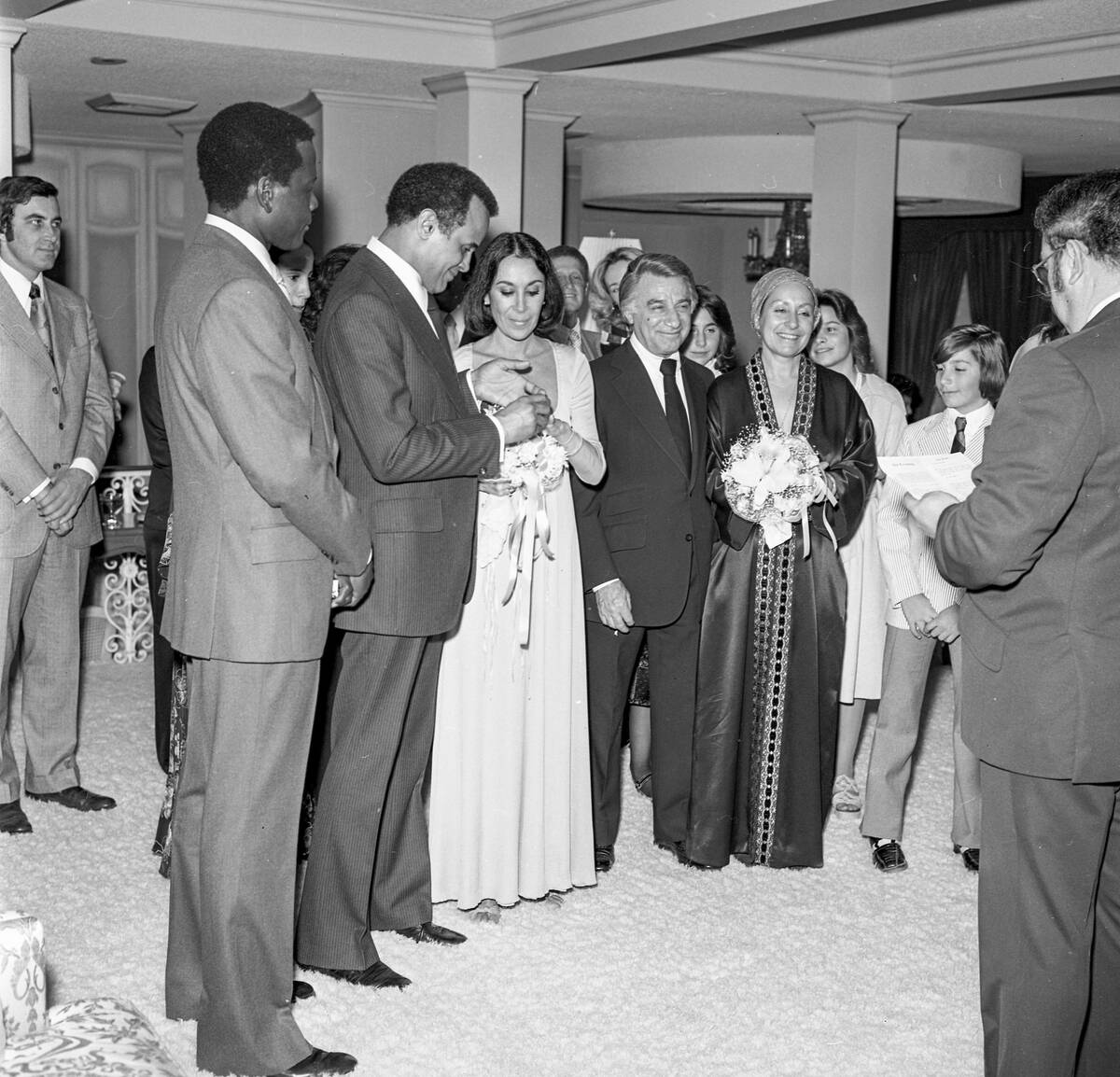 Harry Belafonte and Julie Robinson exchange rings during their wedding on Jan. 25, 1976, at Cae ...