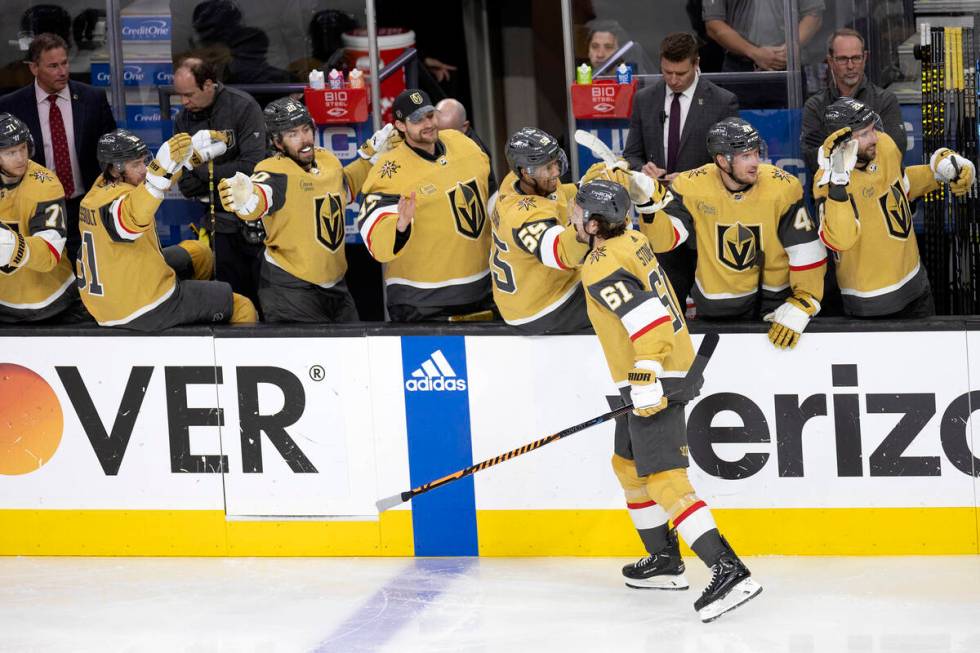 The Golden Knights bench congratulates right wing Mark Stone (61) on his goal during the second ...