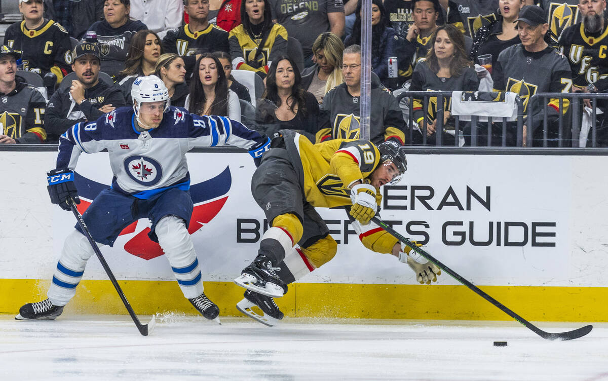 Winnipeg Jets right wing Saku Maenalanen (8) throws Golden Knights right wing Reilly Smith (19) ...