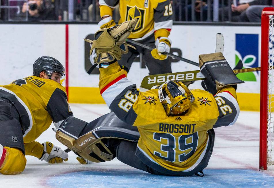 Golden Knights goaltender Laurent Brossoit (39) makes save while falling over against the Winni ...