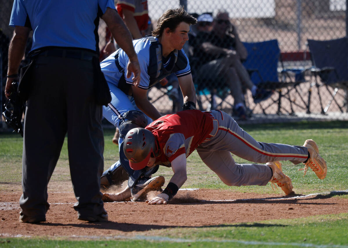 Southeast Career Tech's Luke Hughes (2) is tagged out by Foothill's catcher Michael Gibson (2) ...