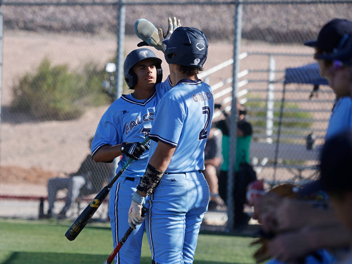 Foothill's Lloyd Strother (42) gets a high-five from his teammate Michael Gibson (2) after scor ...