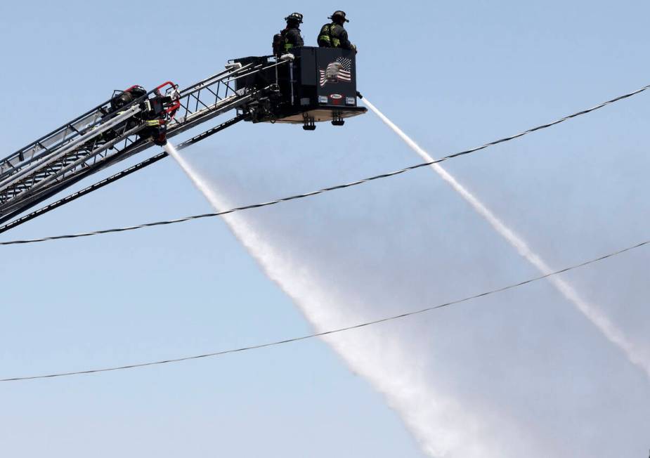 North Las Vegas firefighters try to extinguish a fire around 4565 E. Hammer Lane, Tuesday, Apri ...