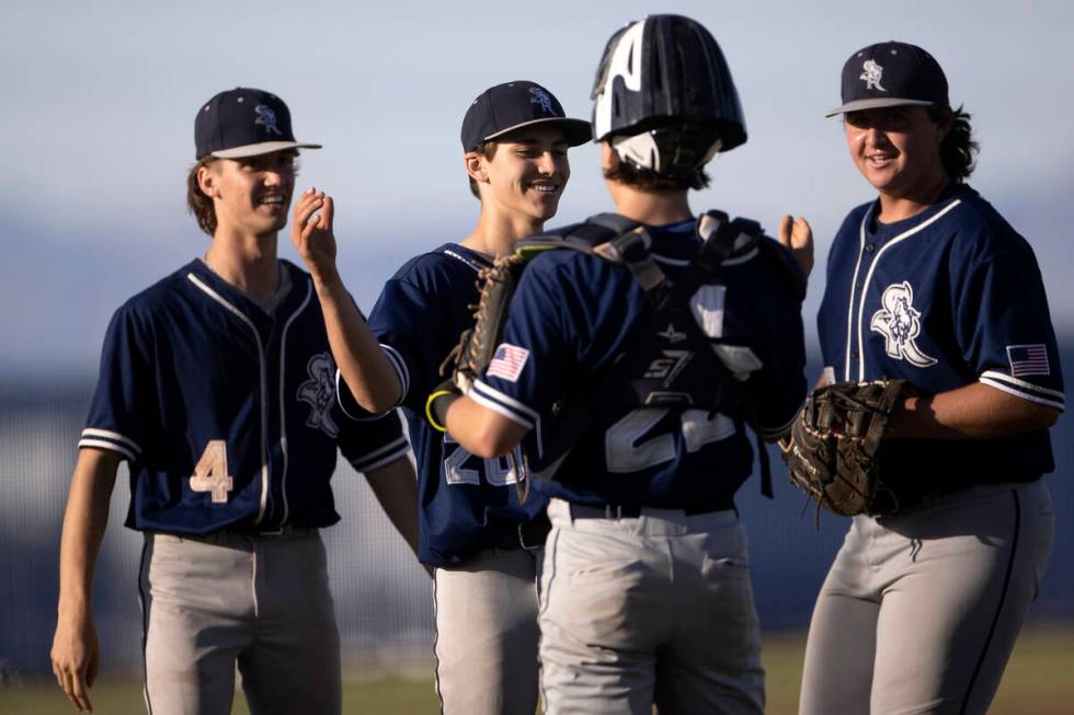 Shadow Ridge outfielder Ben Moss (4), pitcher Brayden Somers, second from left, catcher Austin ...