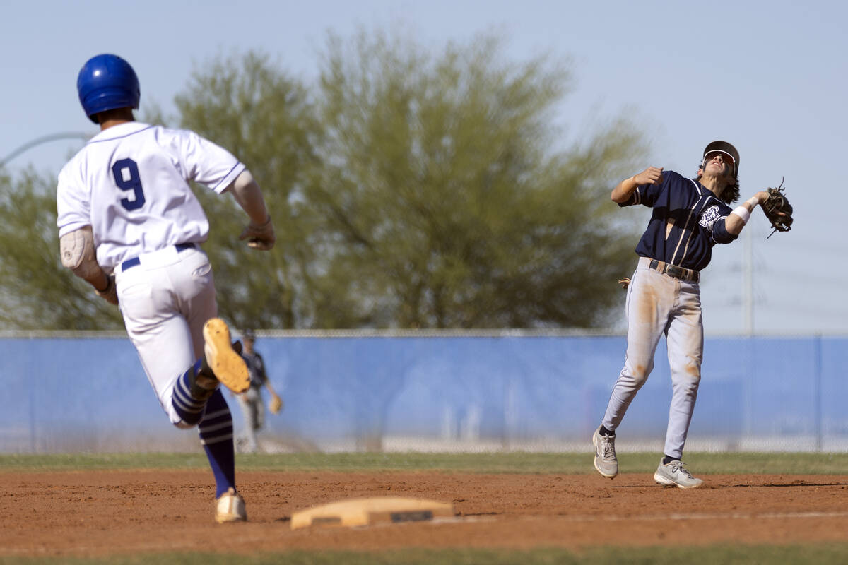 Shadow Ridge shortstop Michael Brown, right, catches for an out while Sierra Vista’s JT ...