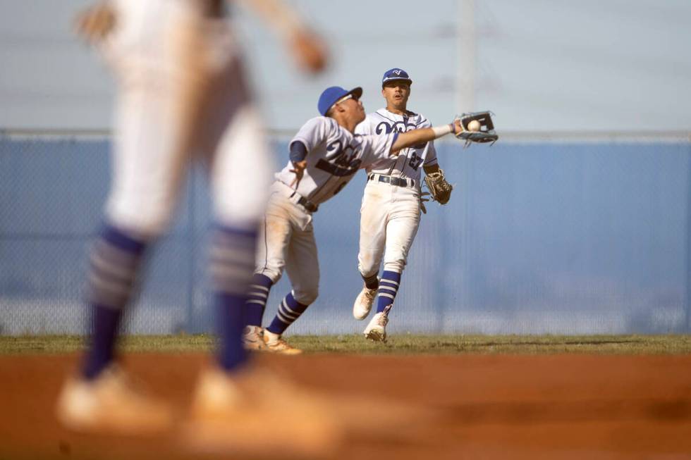 Sierra Vista’s Jayson Schmeisser (27) watches his teammate Alex Guevara catch for an out ...