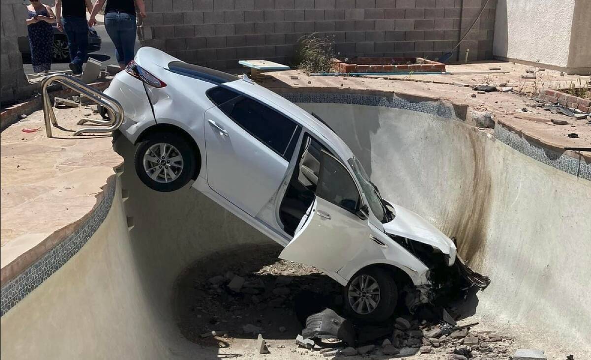 A Kia is seen in a swimming pool in the backyard of a home in central Las Vegas on Wednesday, A ...