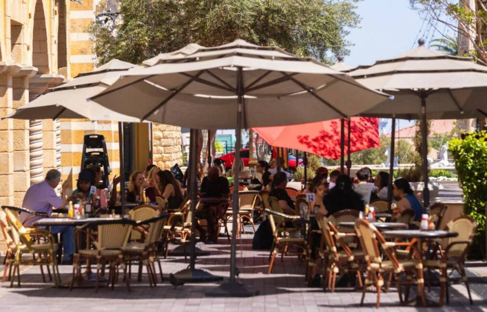 People sit on the patio as they enjoy their lunch at Leone Cafe, on Monday April. 24, 2023, in ...