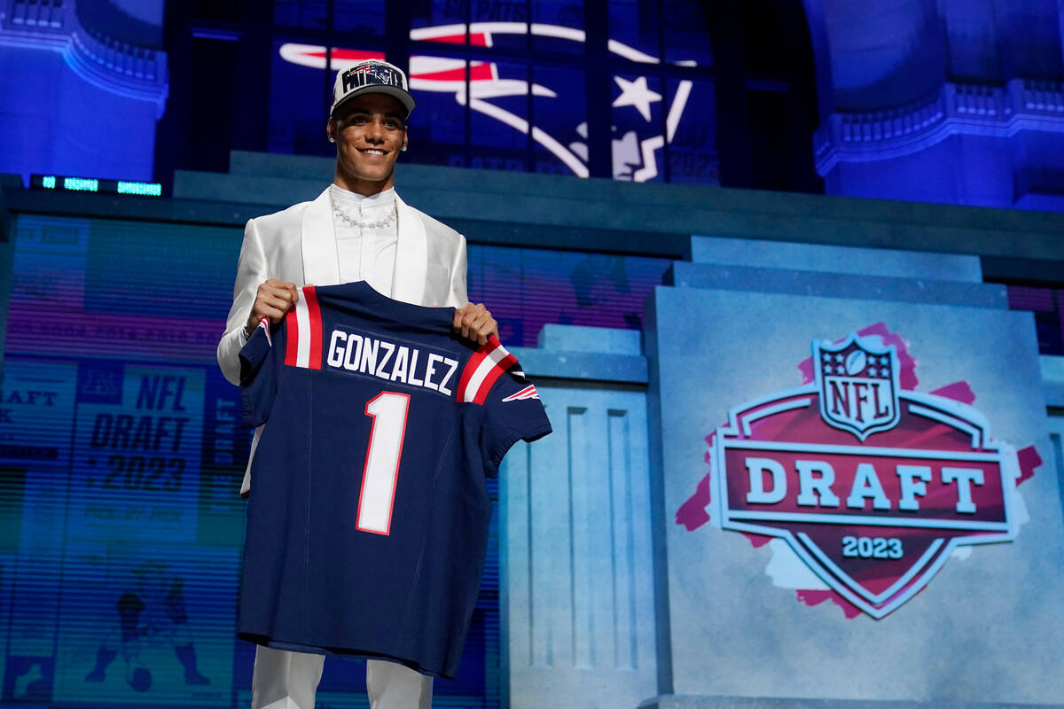 Oregon defensive back Christian Gonzalez stands on stage after being chosen by the New England ...