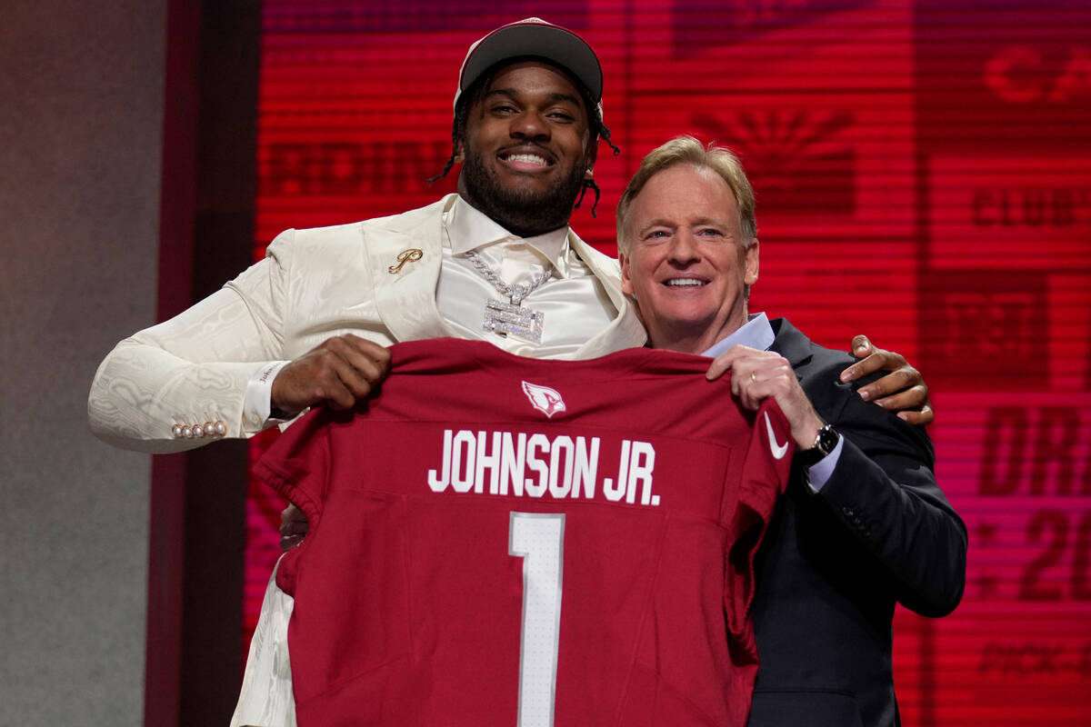 Ohio State offensive lineman Paris Johnson Jr.,left, poses with NFL Commissioner Roger Goodell ...