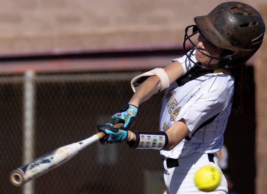 Faith Lutheran left fielder Marin Young bats against Green Valley during a high school softball ...