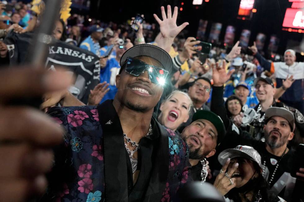 Texas Tech defensive lineman Tyree Wilson takes a selfie with fans after being chosen by the La ...