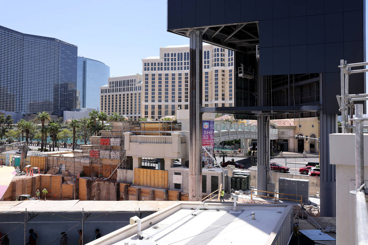 Pedestrians walk between the Horseshoe Las Vegas on the Strip Friday, April 28, 2023. (K.M. Can ...