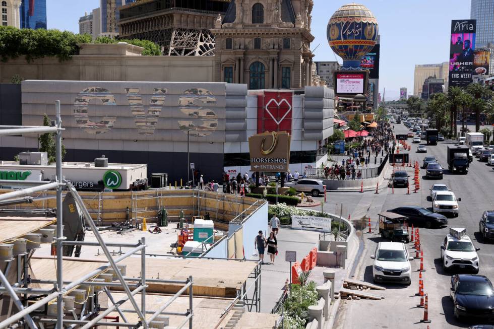 Pedestrians walk between the Horseshoe Las Vegas and Paris Las Vegas on the Strip Friday, April ...