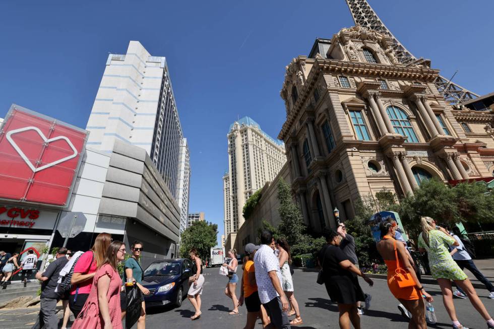 Pedestrians walk between the Horseshoe Las Vegas, left, and Paris Las Vegas on the Strip Friday ...