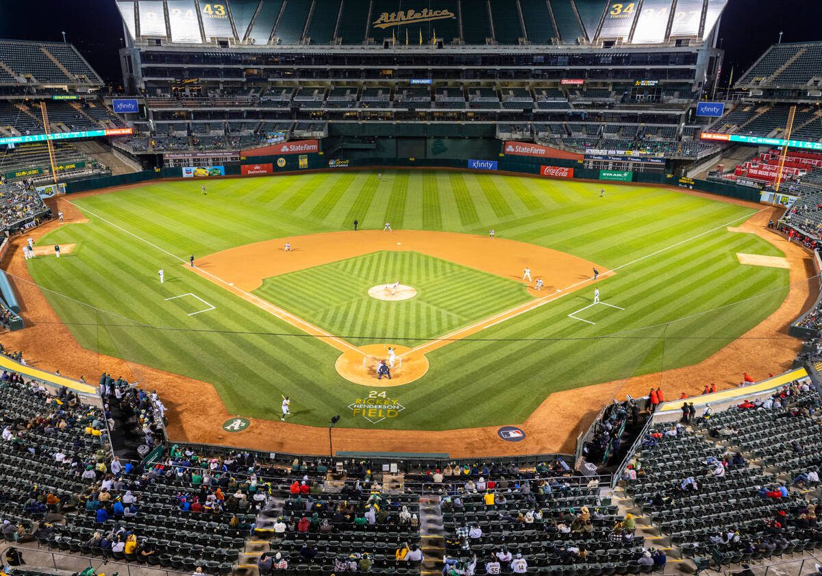 The Oakland A's fans watch a baseball game against the Cincinnati Reds at the Oakland Coliseum, ...