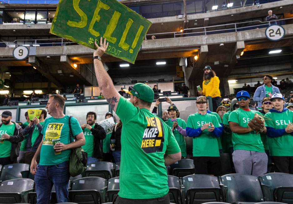 The Oakland A's fans, including Chris Scott, center, protest at the Oakland Coliseum during a b ...