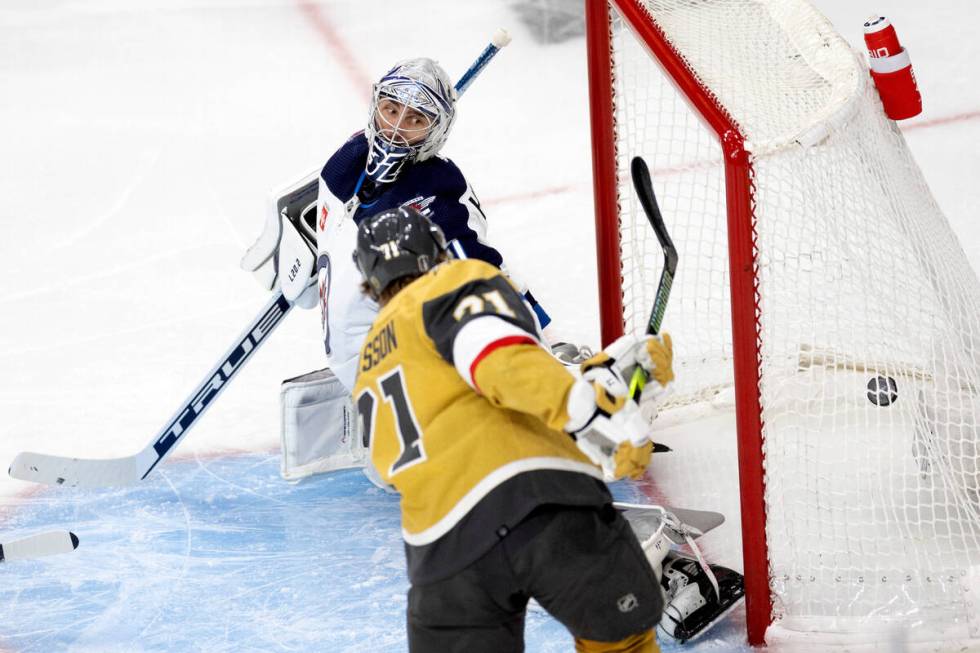 Golden Knights center William Karlsson (71) scores on Winnipeg Jets goaltender Connor Hellebuyc ...