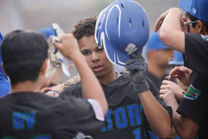 Green Valley's Caden Kirby (12), center, celebrates with his teammates after scoring on a doubl ...