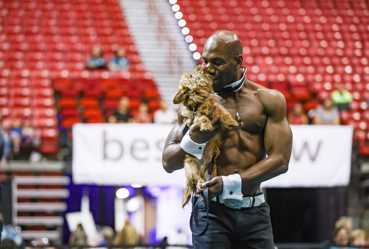 Chippendale performer Will Credell carries Murphy in The Animal Foundation 20th annual Best In ...